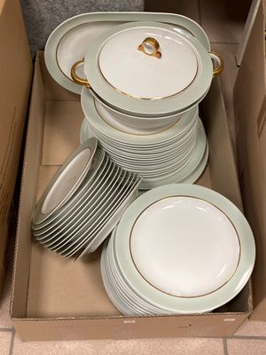 beaucoup d'assiettes dans une boîte posée par terre