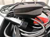 a black bag with a bunch of wires and a remote in it