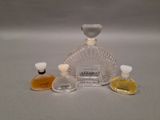 three bottles of perfume sitting next to each other on a table