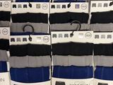 many pairs of men ' s socks on display in a store