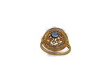 a close up of a gold ring with a blue stone