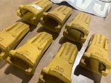 several pieces of yellow construction equipment sitting on top of a table