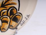 a white plate with a picture of a tiger on it