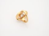 a close up of a gold ring with a diamond in the middle
