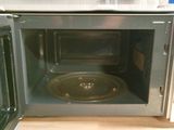 two microwaves that are sitting side by side on the counter