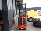 a fork lift truck that is parked in front of a building