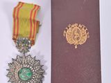 two medals and a book sitting on a table