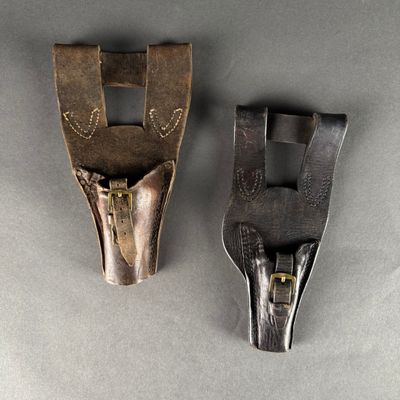 pair of antique leather and brass pliers on a gray surface