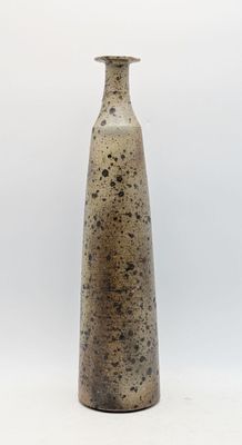 a vase that is sitting on a white surface