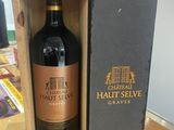 the bottle of chateau haut selve is in a wooden box