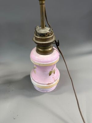 an image of a pink and gold lamp on a white table