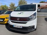 a white van parked in a parking lot next to a yellow car