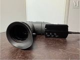 a video camera sitting on a table next to a wall