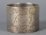 an image of a silver ring with a name engraved on it