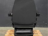 the back of a black office chair on a wooden pallet