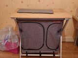 a laptop sitting on a folding chair in a room