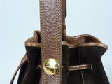 brown sued purse with a gold buckle on a white background