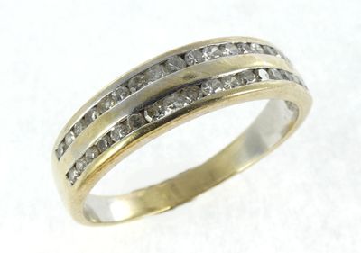 a close up of a ring with two rows of diamonds