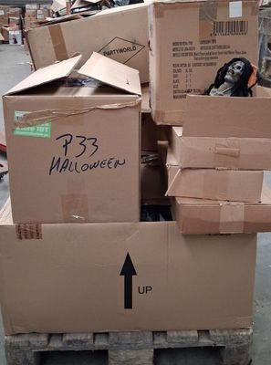 une pile de cartons posée sur une palette, avec un chien à l'intérieur