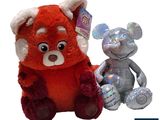 two stuffed animals sitting next to each other on a white background
