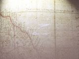 a map on the wall with a red line drawn on it