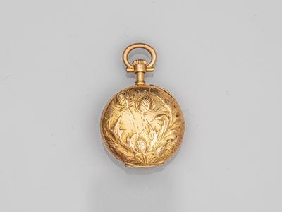 an 18k gold pocket watch with a floral design