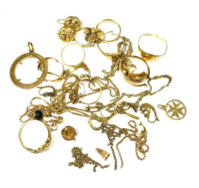 a pile of gold jewelry on a white surface