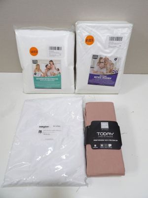 three bags of toilet paper and a towel on a table