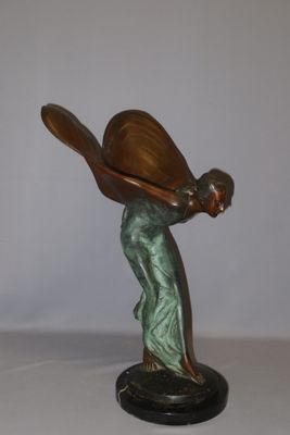 statue of a woman holding a baseball bat on a black base