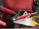 many tools in a red toolbox on the floor