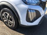 a close up of the front end of a white car