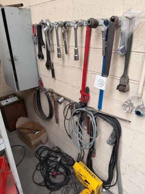 many tools hanging on the wall in the garage