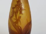 a glass vase with a design of flowers on it