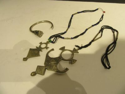 several pieces of jewelry are displayed on a white surface