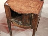 a small wooden table with a drawer on top of it