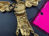 an image of a gold necklace with a leaf on it and a pink tag