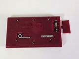 a close up of a red electronic device on a white surface