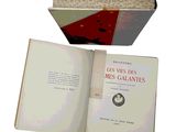 opened book on a white background with a red cover and a black and white photo