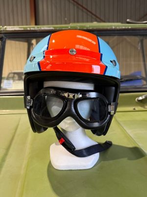 a helmet and goggles sitting on top of a green car