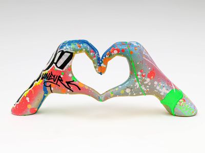 two hands making a heart with graffiti paint on them