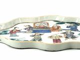 a white tray with a picture of people and a boat on it