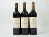 three bottles of wine sitting on top of a white table