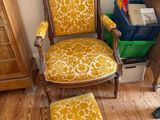 a chair and ottoman in the corner of a room