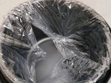 a trash can wrapped in plastic and sitting on the floor