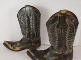 pair of brown cowboy boots on a white background