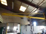 a crane that is hanging from the ceiling in a building