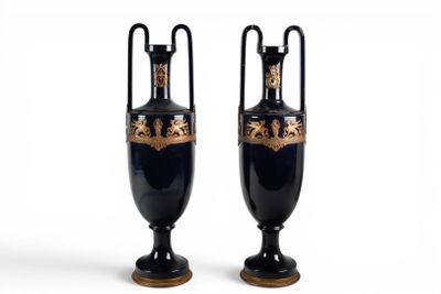 une paire de vases noirs et dorés sur fond blanc