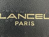 a close up of a black bag with a gold logo on it