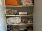 a closet with a lot of items on the shelves