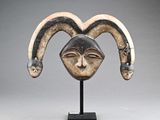 a close up of a sculpture of a goat ' s head on a stand
